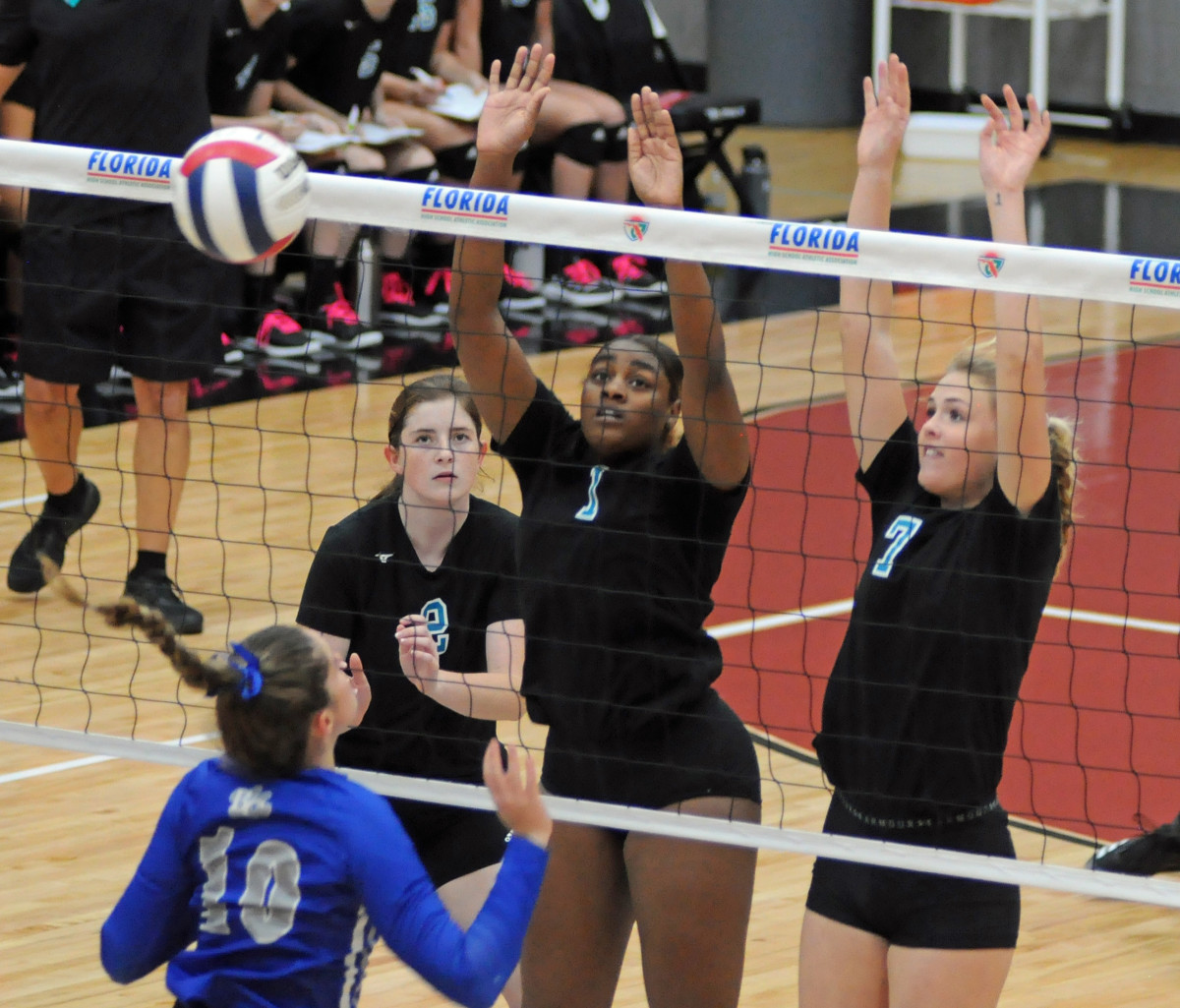 Jensen Beach's Kiosha Smith (1) and Catherine Hamilton (7) block an attack from Barron Collier's Keira Kruk (10) during their Class 5A volleyball final.